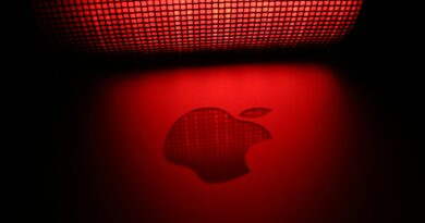 Artistic photo of a glowing apple-shaped graphic with a checkered pattern and red background.