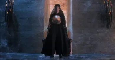 Morpheus the Endless Lord of the Dreaming, standing in black robes while holding a talisman