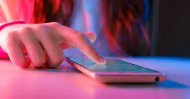 Desativar reprodução automática nas redes sociais 2 Mão usando smartphone para Desativar a reprodução automática nas redes sociais