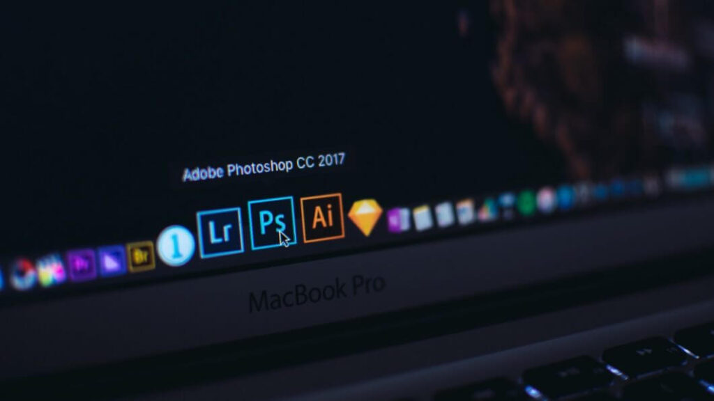 Computador exibindo ícones de programas da Adobe